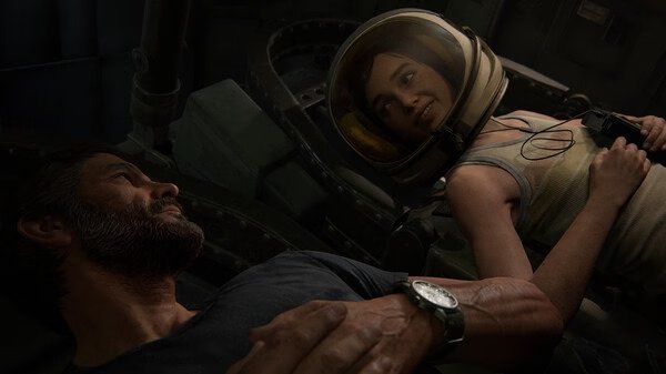 A screenshot from The Last of Us Part II Remastered showing two characters in a dimly lit space. One wears a helmet, holding a camera.