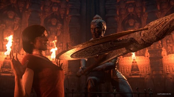 Screenshot from UNCHARTED: Legacy of Thieves Collection showing a character facing a large statue with a weapon.