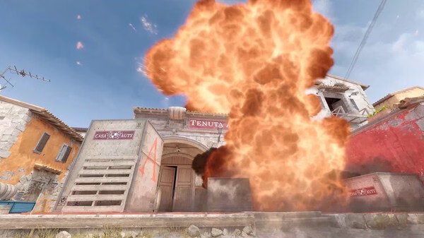 Explosion in front of a building in Counter-Strike 2. The fiery blast fills the scene. Game screenshot.
