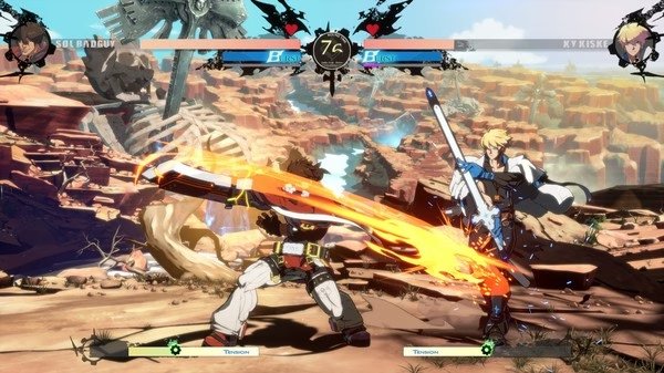 Screenshot of GUILTY GEAR -STRIVE- showing a battle between Sol Badguy and Ky Kiske in a desert-like arena with a 76-second timer.