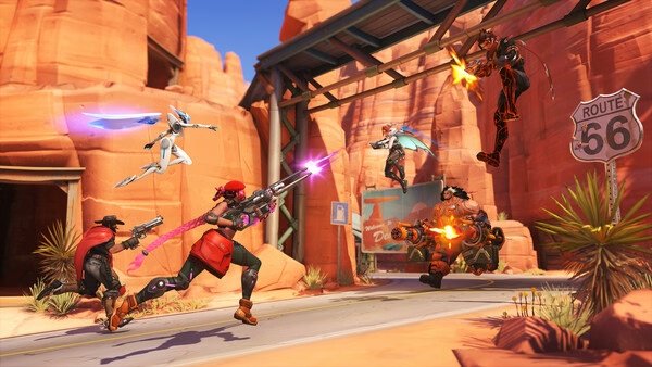 Overwatch® screenshot: Action-packed battle on Route 66 with heroes McCree, Sojourn, Genji, and others exchanging fire.