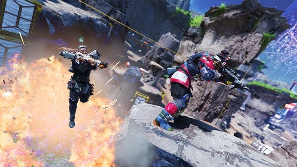 Apex Legends™ screenshot: Two characters engage in a dynamic firefight amidst rocky terrain, with one leaping from an explosion.