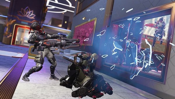 Apex Legends™ screenshot: Two characters in combat, one firing a weapon, while glass shatters from a nearby explosion.