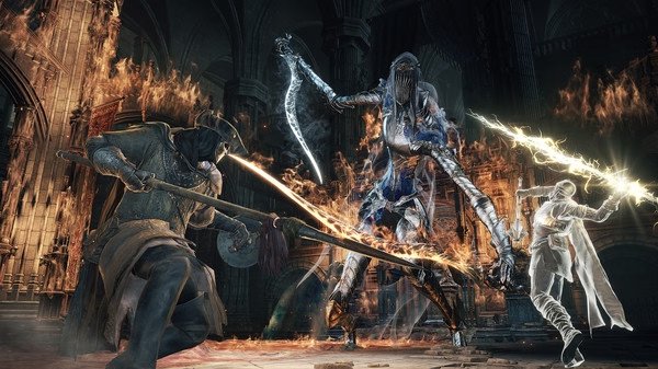 DARK SOULS™ III screenshot: Three armored warriors wielding swords and shields engage in battle amidst flames in a dark cathedral.