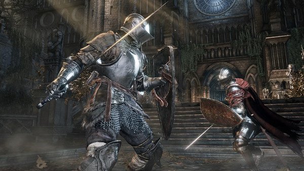 Screenshot from DARK SOULS™ III showing two armored knights locked in combat in front of a grand cathedral.