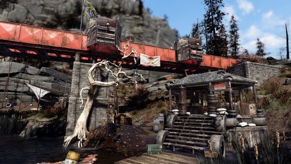 Fallout 76 screenshot of a red bridge, a shack with wooden stairs, and a twisted white tree in a rugged, outdoor landscape.