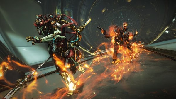 Screenshot from Warframe showing two armored characters, one wielding a staff and the other engulfed in flames, in a futuristic corridor.