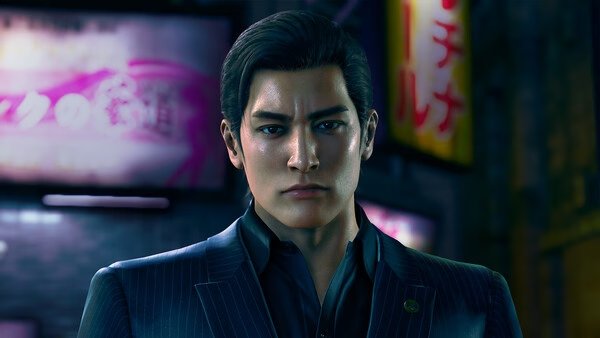 Screenshot from Yakuza Kiwami 3 & Dark Ties showing a man in a suit standing in a city street at night.
