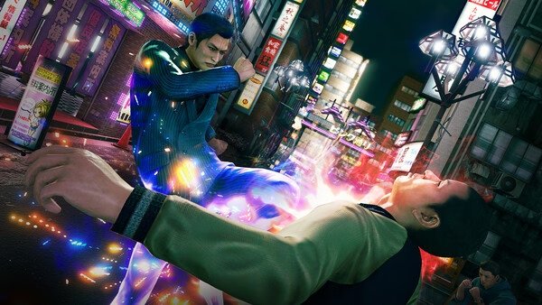 Screenshot from Yakuza Kiwami 3 & Dark Ties showing a dynamic street fight with glowing effects in a bustling city setting.
