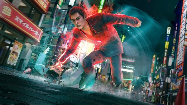 A screenshot from Yakuza Kiwami 3 & Dark Ties shows a glowing character attacking an opponent in a bustling neon-lit street.