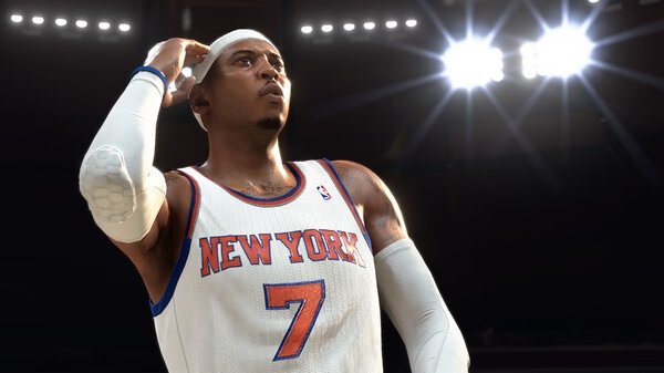 NBA 2K26 screenshot: A basketball player in a New York jersey, number 7, stands under bright arena lights.