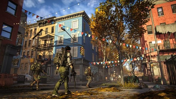 Screenshot from Tom Clancy’s The Division® 2 showing armed agents walking through a colorful urban street decorated with festive banners.