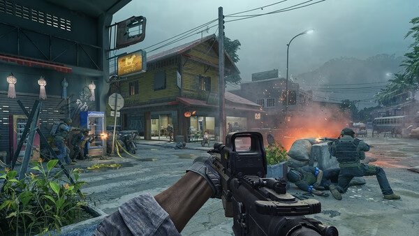 Gray Zone Warfare screenshot: A player aims an assault rifle in a street battle as teammates take cover near burning debris.
