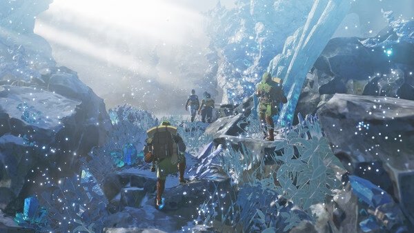 Screenshot from Monster Hunter Stories 3: Twisted Reflection showing hunters trekking through a sparkling, icy cave.