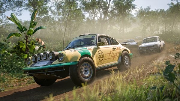 Forza Horizon 5 screenshot: A rally car races through a lush, tropical forest with other cars in the background.