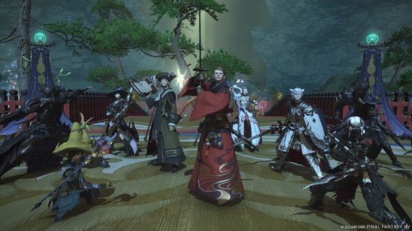 Group of players in elaborate costumes pose in a scenic area in this FINAL FANTASY XIV Online screenshot.