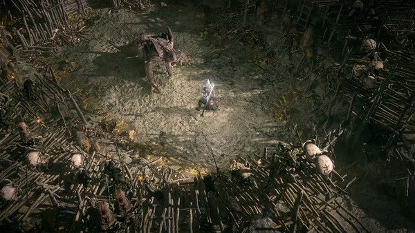Path of Exile 2 screenshot: A warrior faces a large creature in an arena surrounded by wooden spikes and skulls.