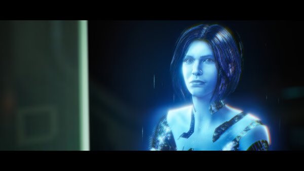A holographic character appears in this Halo: Campaign Evolved screenshot, glowing with blue light and digital effects.