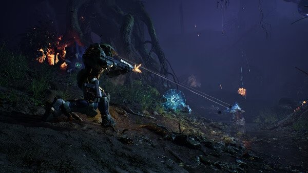 Halo: Campaign Evolved screenshot featuring a soldier firing at alien creatures in a dark, forested environment.
