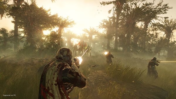 HELLDIVERS 2 screenshot: Players in armor engage a large alien creature in a lush forest at sunset, with weapons firing.