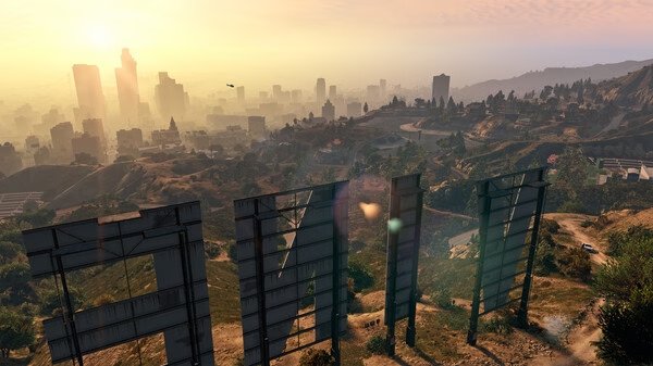 Screenshot from Grand Theft Auto V showing a panoramic view of Los Santos cityscape at sunset from behind the Vinewood sign.