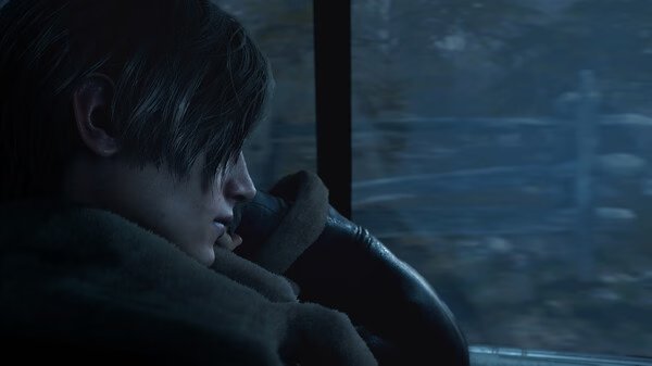 Resident Evil 4 Remake screenshot: A character in a leather jacket sits inside a vehicle, looking out at a blurred, forested landscape.