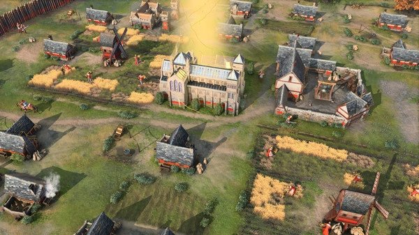 Age of Empires IV screenshot showing a medieval village with farms, houses, windmills, and a central church bathed in sunlight.