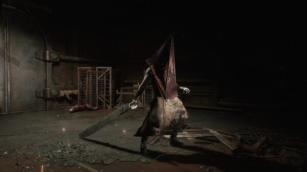 Silent Hill 2 screenshot: Pyramid Head stands in a dimly lit room holding a large blade, surrounded by debris and cages.