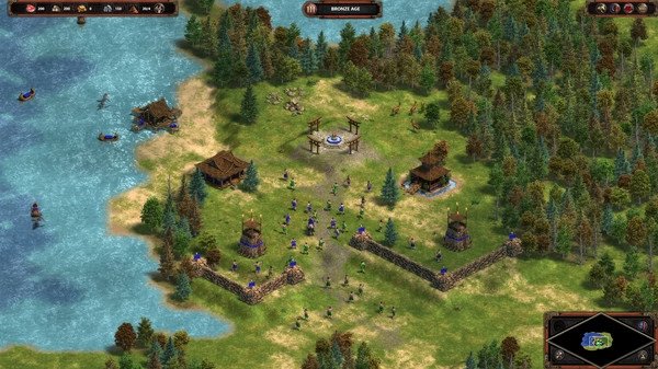 Screenshot of Age of Empires Definitive Edition showing a village with walls, soldiers, and a river nearby.