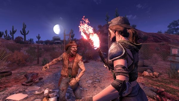 Screenshot from 7 Days to Die: A player character in armor holds a torch, facing a zombie in a desert landscape at night.
