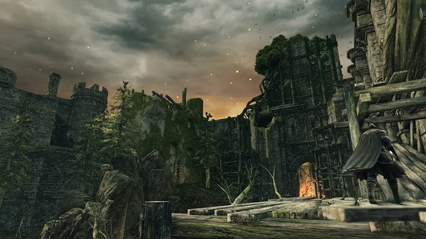 Screenshot from Dark Souls II: Scholar of the First Sin showing a character in a medieval castle with a fiery glow in the background.