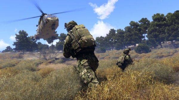 Arma 3 screenshot: Soldiers in camouflage gear move through dry terrain as a helicopter hovers above under a clear blue sky.