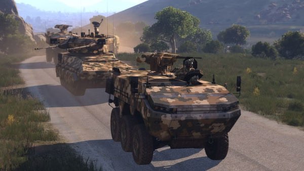 Arma 3 screenshot showing two camouflaged armored vehicles on a dirt road, surrounded by trees and hills under a clear sky.