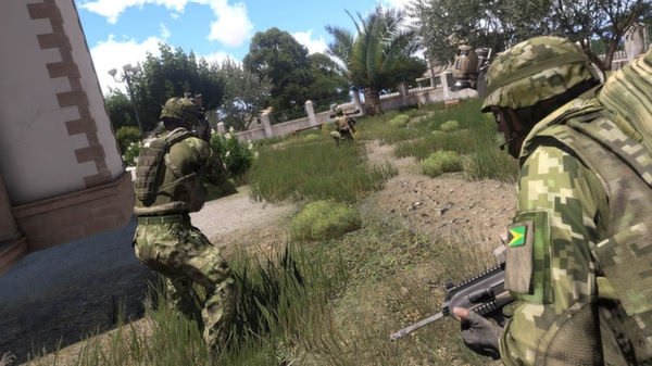 Arma 3 screenshot: Soldiers in camo gear navigate a grassy field near a building, with trees and clear skies in the background.