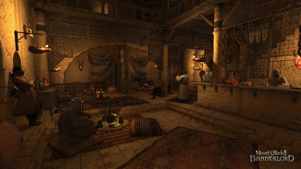 Mount & Blade II: Bannerlord screenshot showing a cozy medieval tavern interior with patrons sitting on rugs and a bartender at the counter.