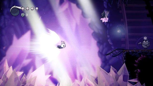 Screenshot from Hollow Knight showing the protagonist dashing through a crystal cave, with a flying enemy nearby.