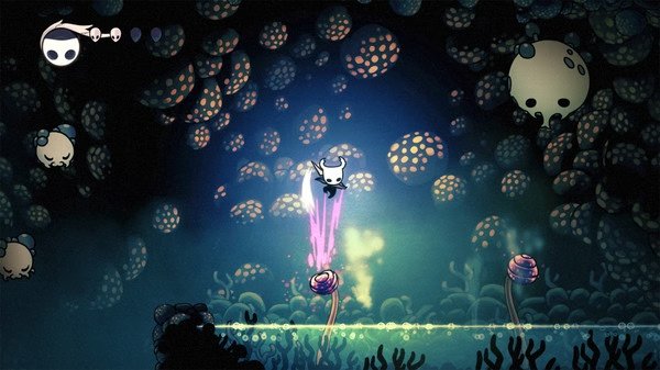Hollow Knight screenshot: The Knight jumps over glowing mushrooms and jellyfish-like creatures in a luminescent, cavernous area.