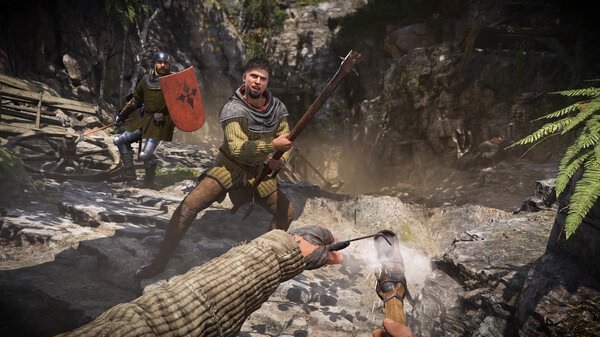 Screenshot from Kingdom Come: Deliverance 2 showing a medieval battle scene with armored warriors in a rocky forest setting.