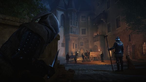 A nighttime scene in Kingdom Come: Deliverance 2 screenshot; a hooded figure hides, observing guards near a cart in a medieval town square.