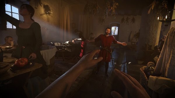 Screenshot from Kingdom Come: Deliverance 2 showing a medieval tavern scene with a standing man in red and seated patrons.