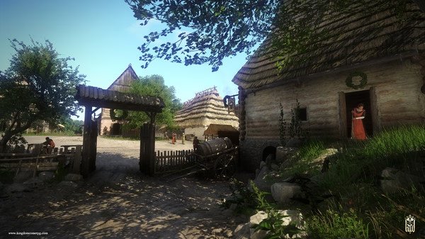 Screenshot from Kingdom Come: Deliverance showing a rustic village scene with timber houses and a woman standing in a doorway.