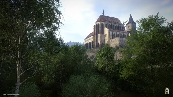 Screenshot from Kingdom Come: Deliverance showing a majestic hillside castle surrounded by lush green trees under a clear sky.